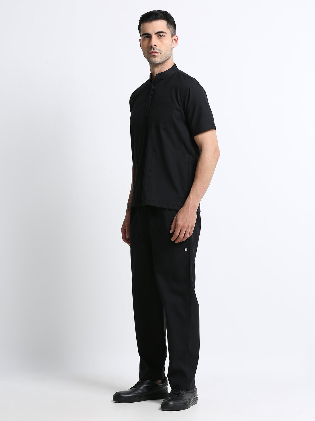 Male healthcare professional comparing V-neck and Mandarin collar Scrubmode scrubs