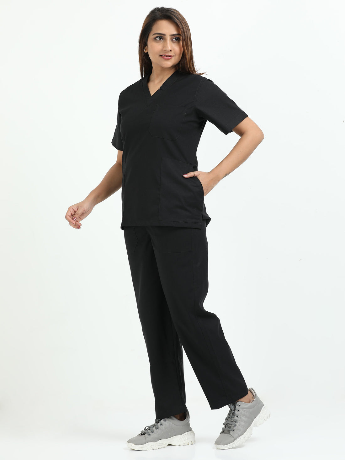 Female healthcare professional wearing black medical scrubs in a modern hospital