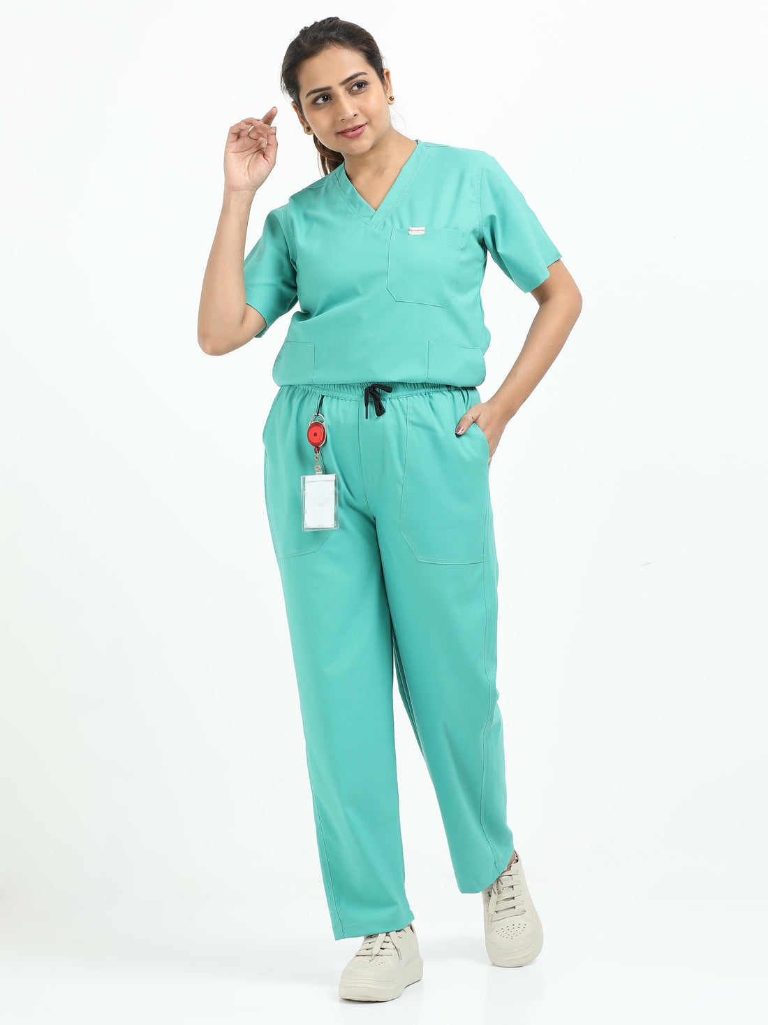 Female operation theatre healthcare professional wearing sea green medical scrubs in a clinical environment