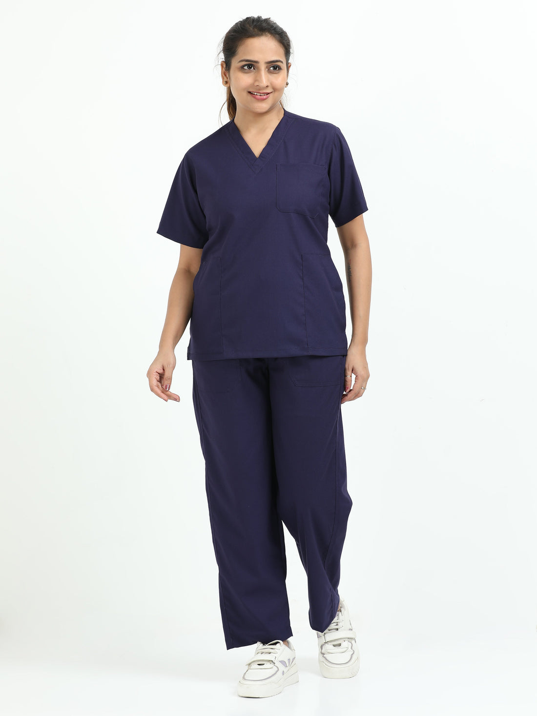 Female healthcare professional wearing navy blue medical scrubs in a hospital