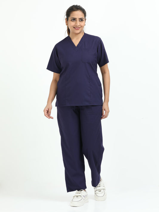 Female healthcare professional wearing navy blue medical scrubs in a hospital